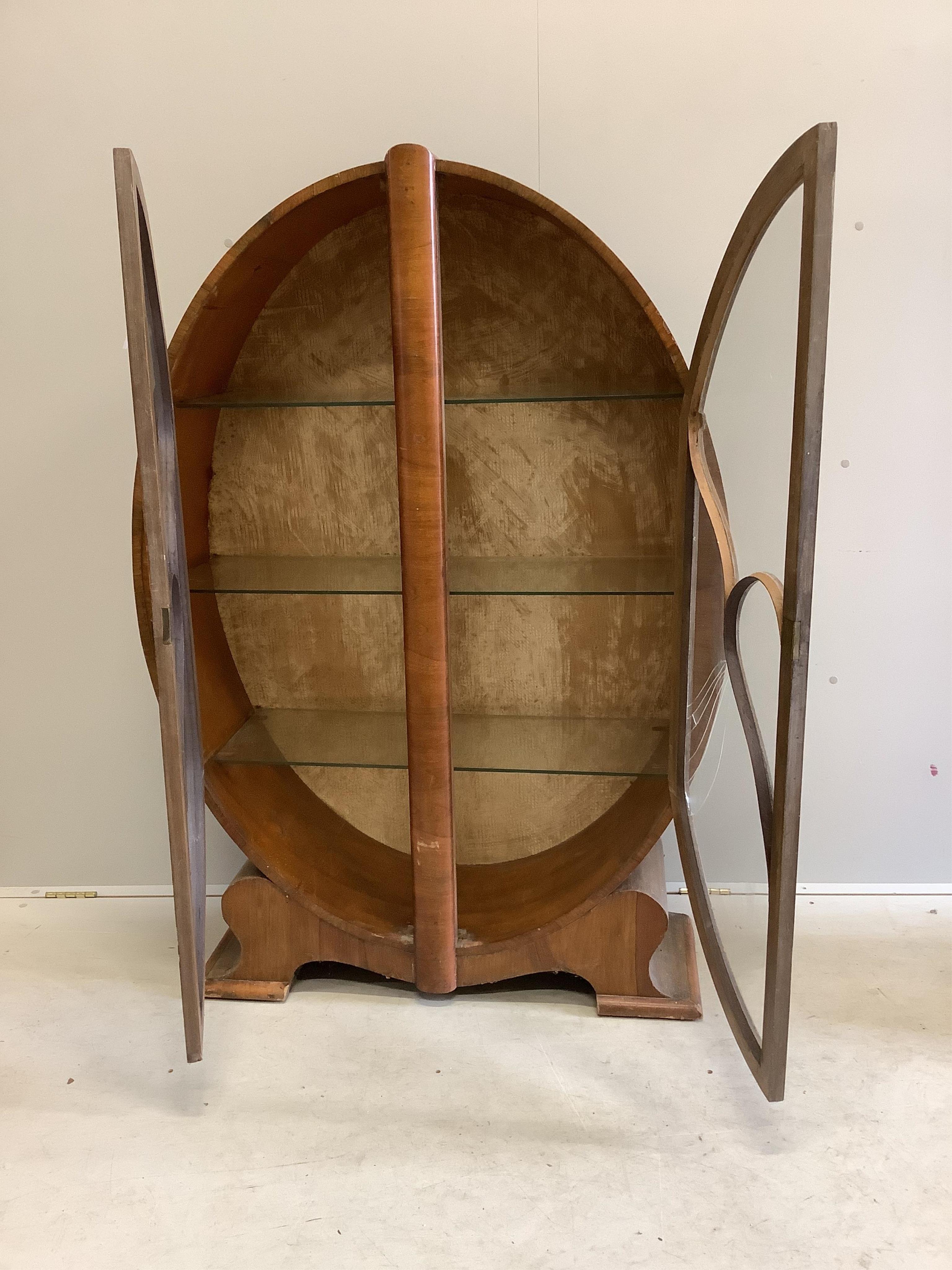 An Art Deco walnut display cabinet, width 98cm, depth 32cm, height 142cm. Condition - poor, one glass pane damaged